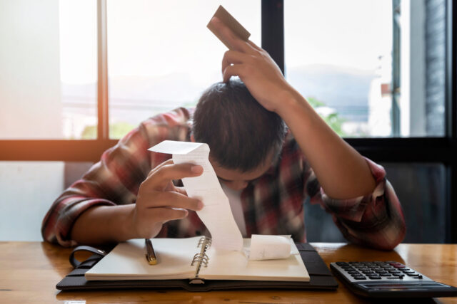 Stressed man with huge amount of credit card debt.