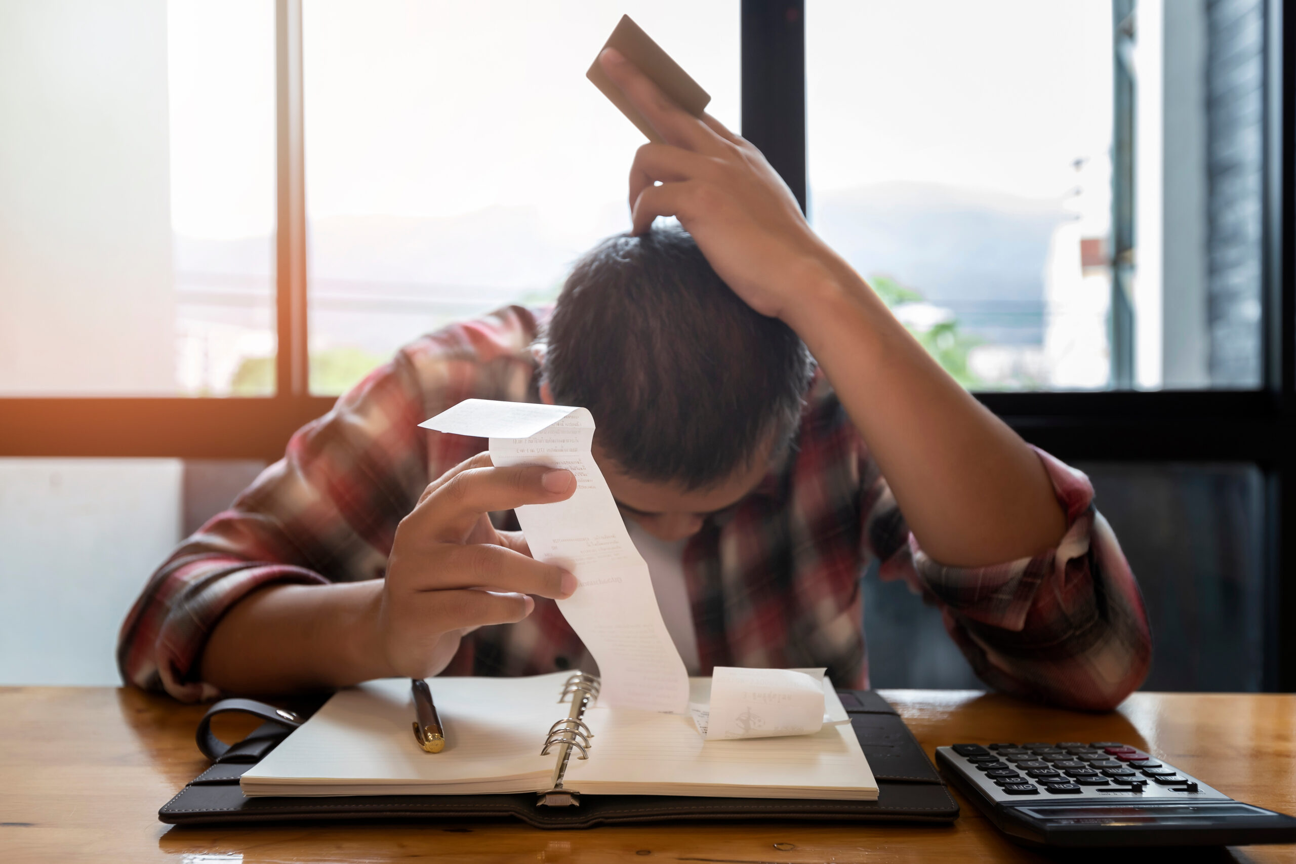 Stressed man with huge amount of credit card debt.