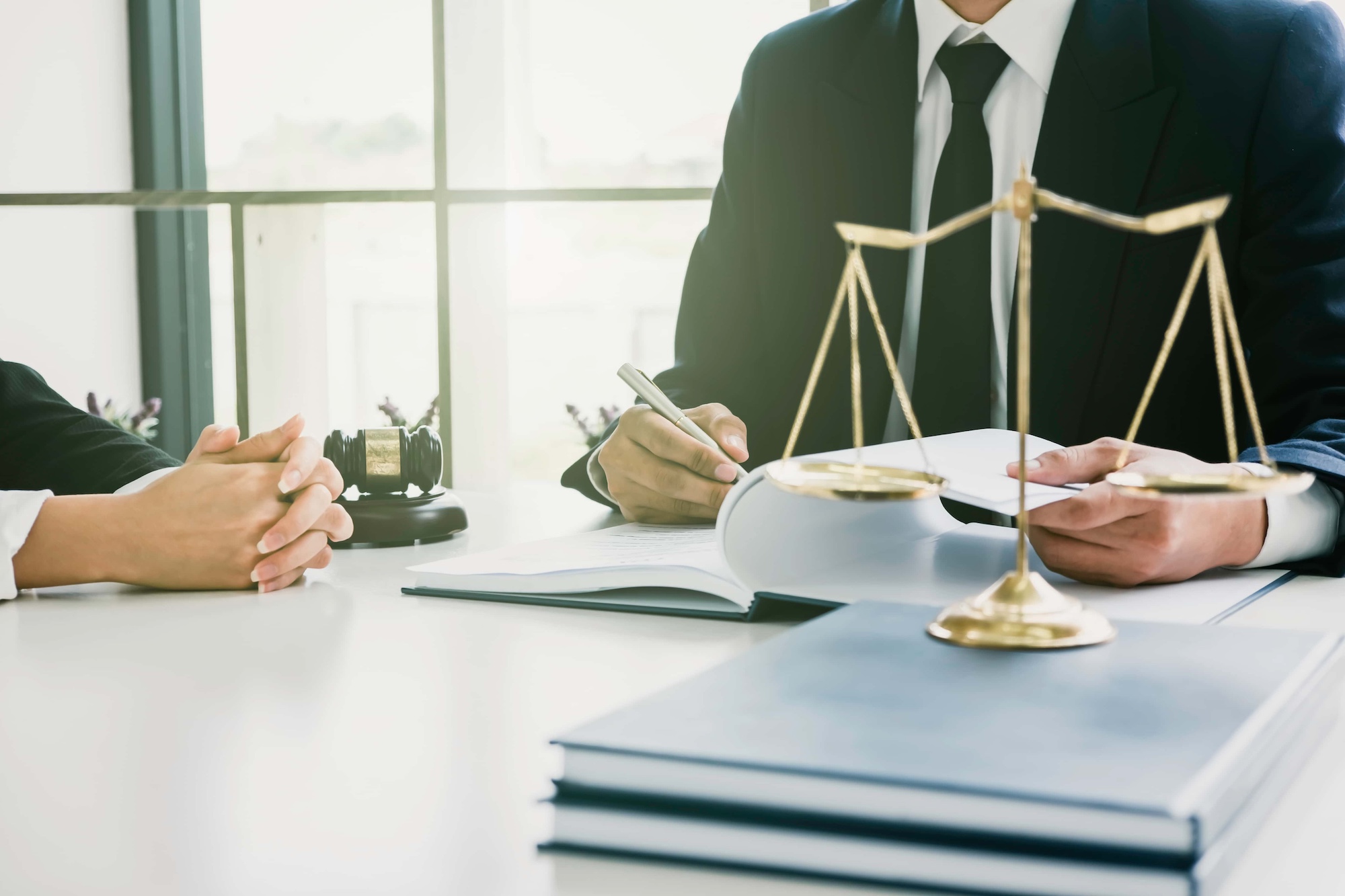 Justice lawyer meeting with contract papers and Judge gavel on tabel in courtroom