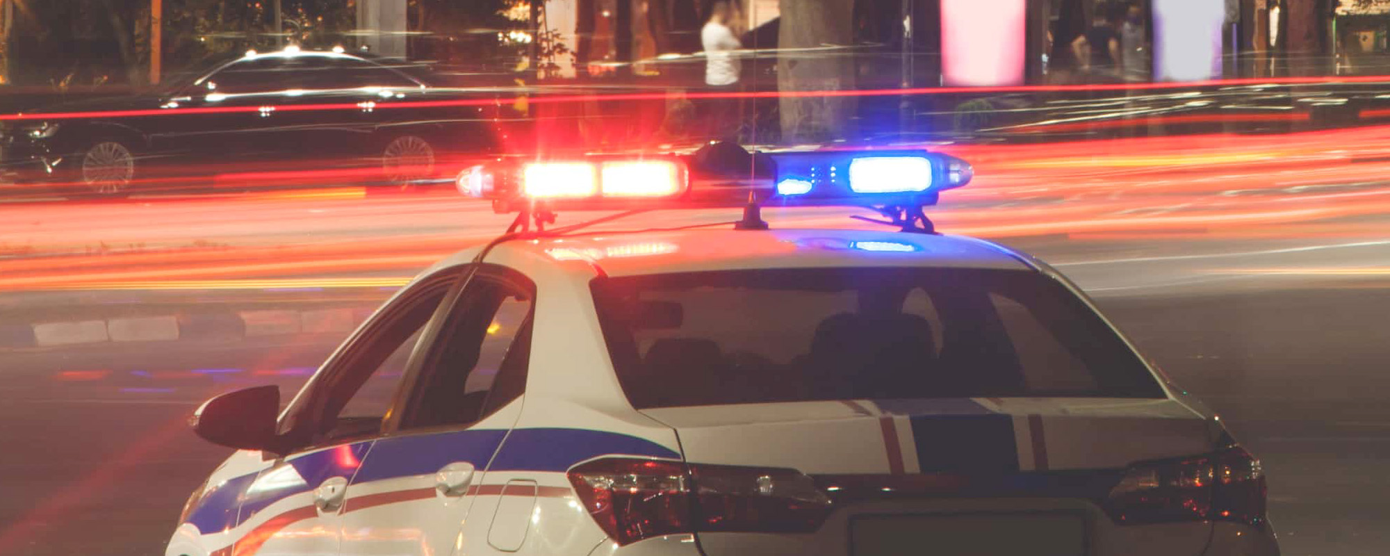 Red and blue light flasher. Police car in the city Night traffic