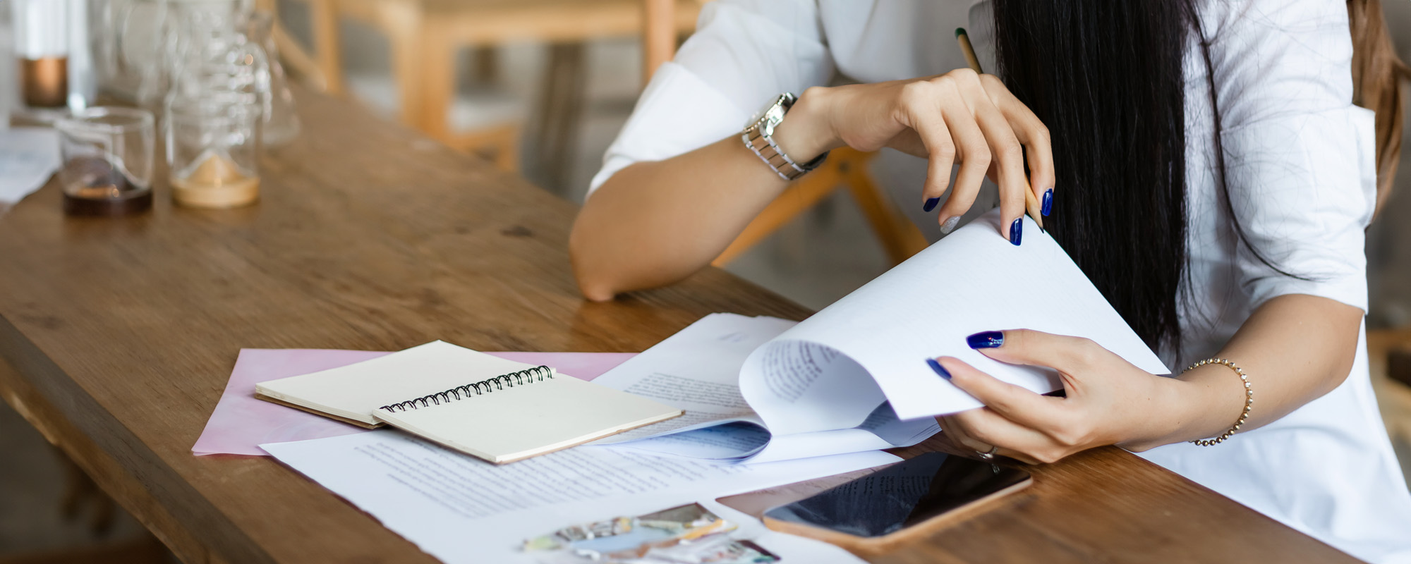 Young businesswoman looking and read information from paperwork on desk in cafe