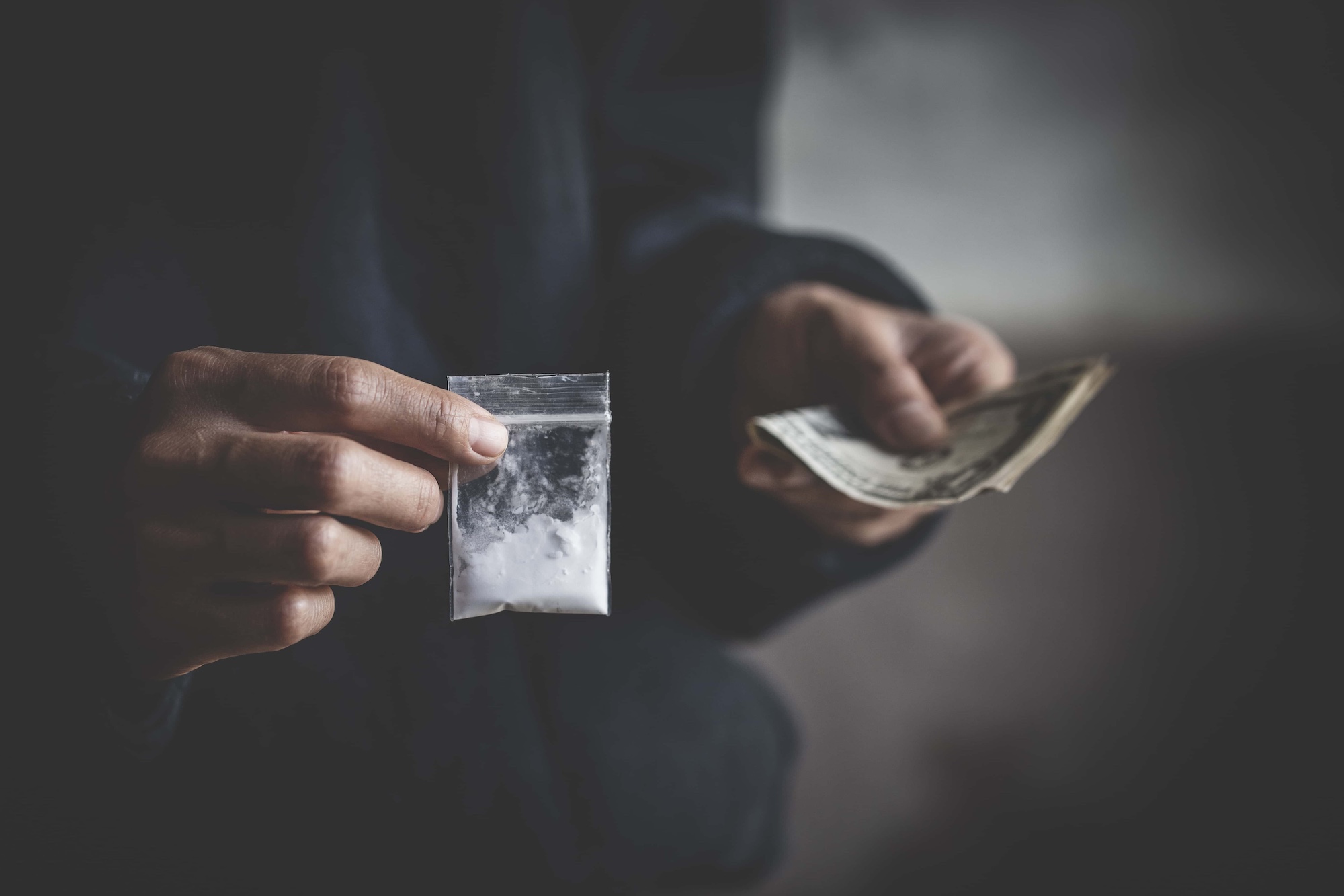 close up of addict with money buying dose Purchase possession and sale of drugs is punishable by law. drug trafficking addiction and sale concept
