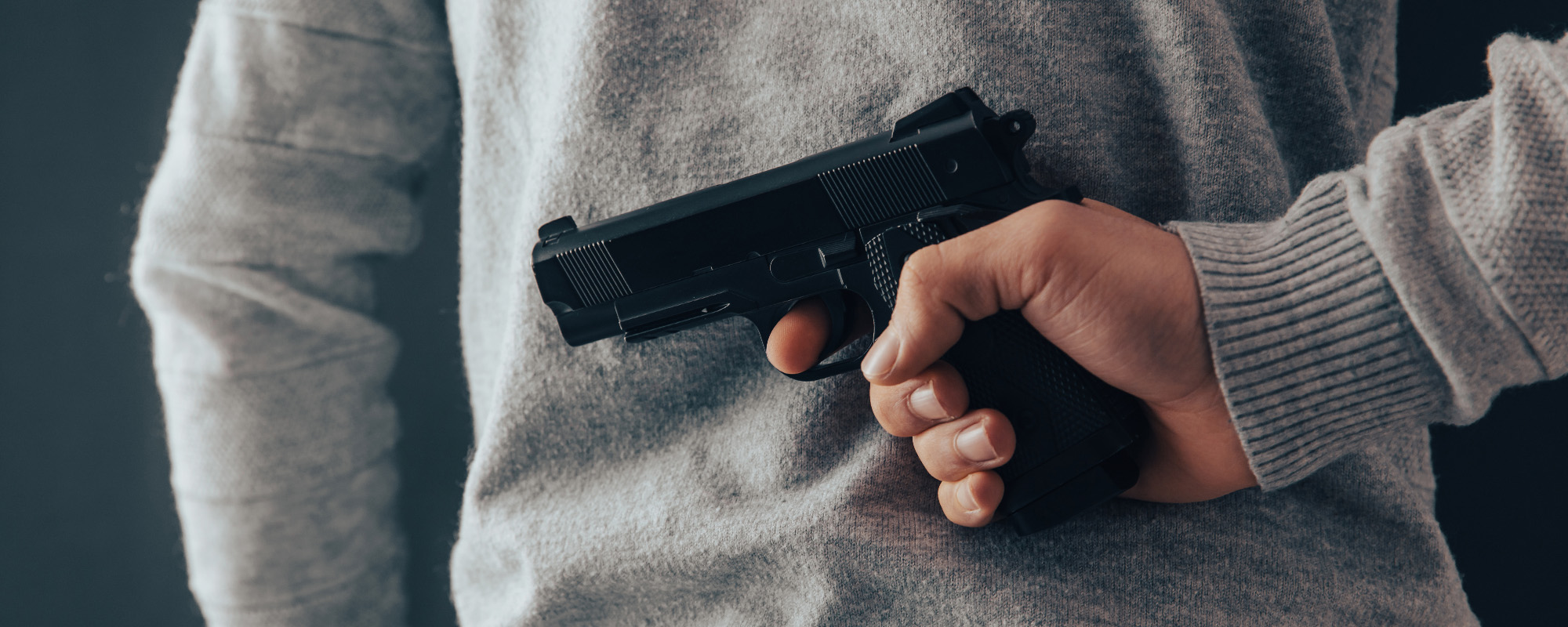 man hand gun in back