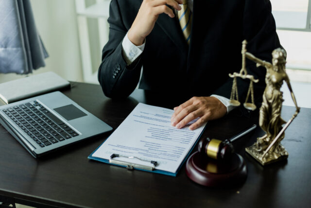 Court of Justice and Judicial: Male Public Defender Writes Arguments for Defense Strategy A successful lawyer fights for her client's freedom with evidence backing it up close.